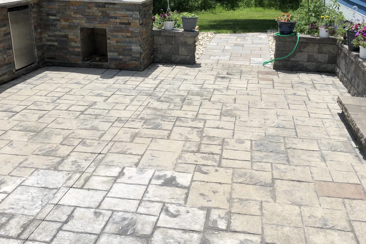 before-antiquing-stain-auburn-light-charcoal-stamped-ashlar-pattern-concrete-patio Close-up of worn stamped concrete surface showing discoloration and loss of color