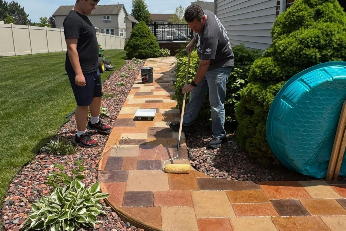 easyseal-sealer-application-antiquing-stain-auburn-khaki-terracotta-yukon-ashlar-pattern-walkway First coat of EasySeal Gloss being rolled onto Auburn, Khaki, Terracotta and Yukon Gold stained concrete for color enhancement.