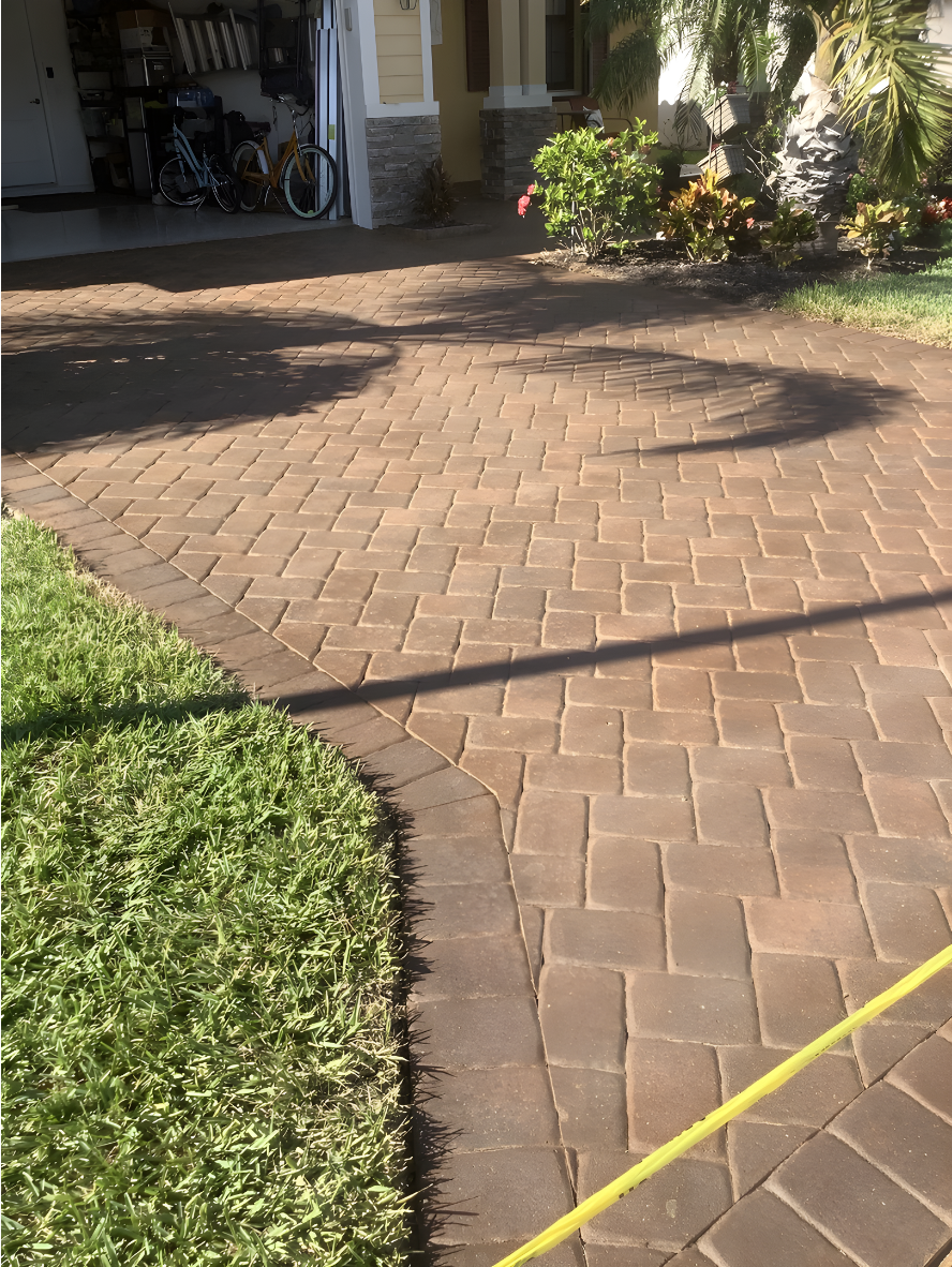 paver driveway refreshed with Caf Royale Portico Full view of a paver driveway stained in Café Royale, highlighting a rich, natural tone and restored finish.