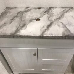 Bathroom Vanity with Pearl and Whale Accents on a Gray Base Color Faux Marble Countertop Finish